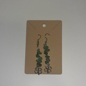 Handmade gemstone earning with a four leaf clover at the bottom.